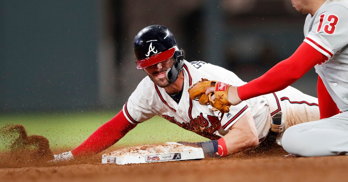 Atlanta Braves' Dansby Swanson beats the tag from Philadelphia Phillies second baseman Asdrubal Cabrera (13) as he steals second base during the eighth inning of a Sept. 20 game in Atlanta.
