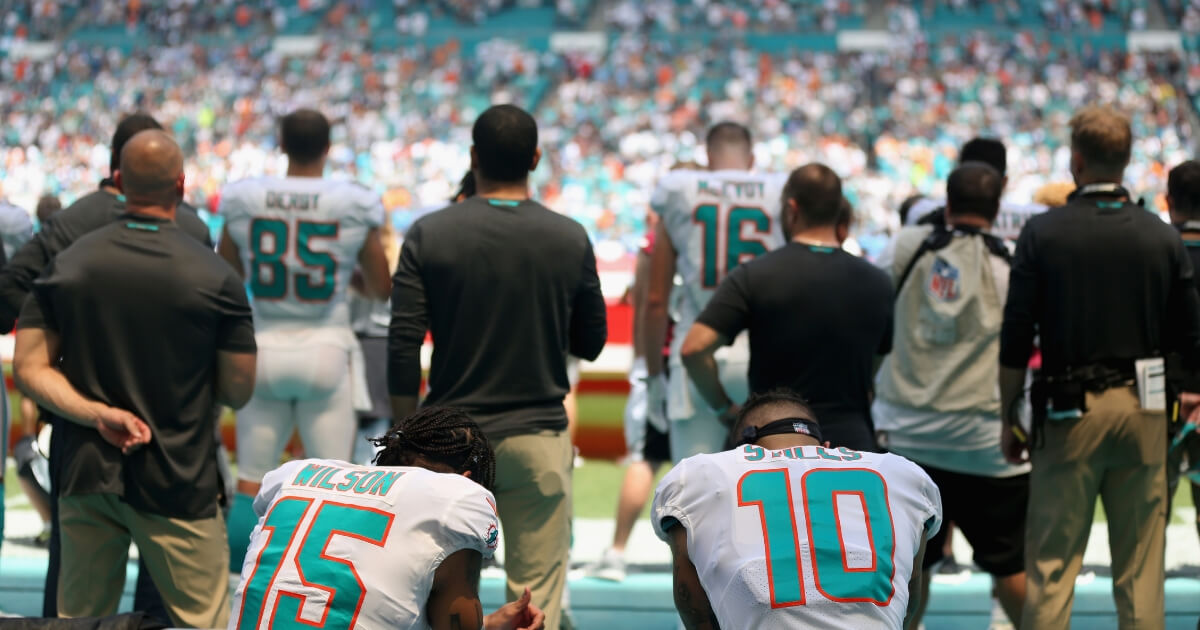 Miami Dolphins receivers Kenny Stills and Albert Wilson of kneel during the national anthem before their game against the Tennessee Titans at Hard Rock Stadium on Sept. 9.