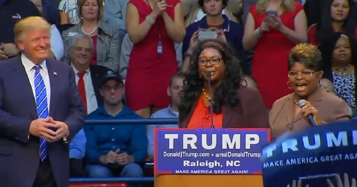 Donald Trump is pictured on stage with supporters Diamond and Silk during a campaign rally in Phoenix, Arizona, in December 2015