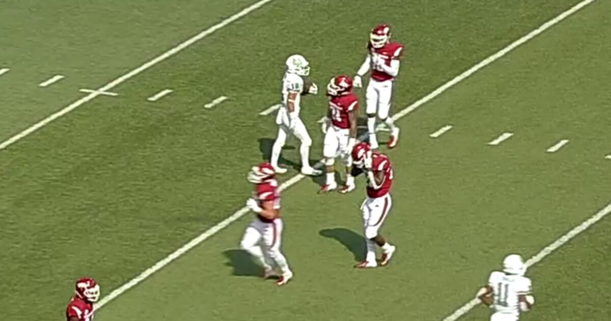University of Arkansas players (in red) walk away from North Texas return specialist assuming he made a fair catch. Instead, he took off running for a 90-yard touchdown.