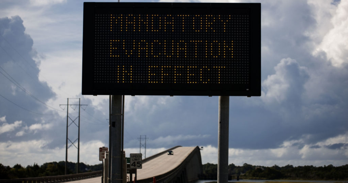 A sign stating 'Mandatory Evacuation in Effect' can be seen at the bridge over the intercoastal waterway in Cedar Point, North Carolina on Wednesday in advance of Hurricane Florence.