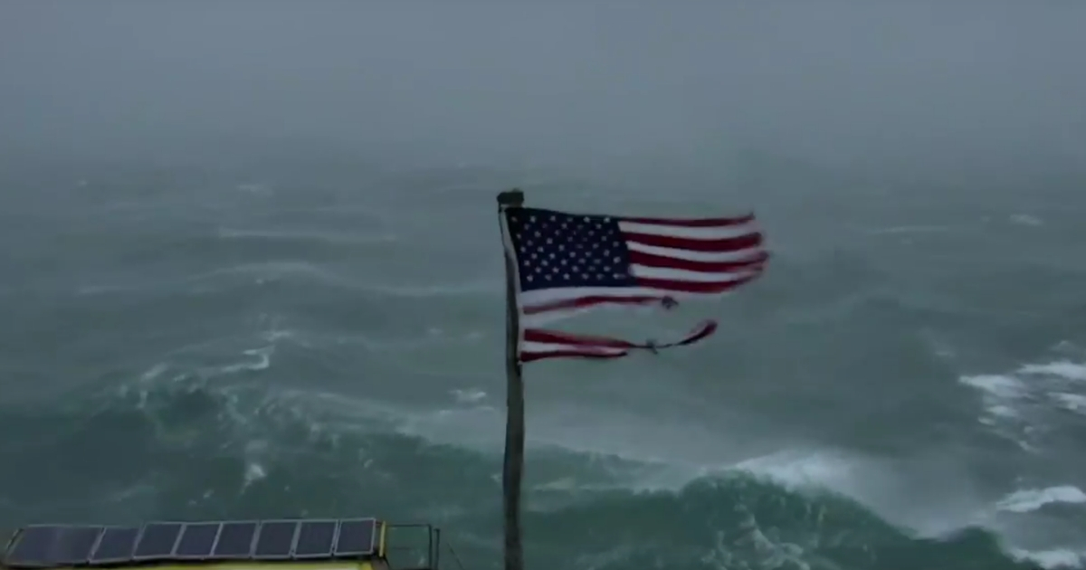 An American flag is torn and battered by Hurricane Florence.