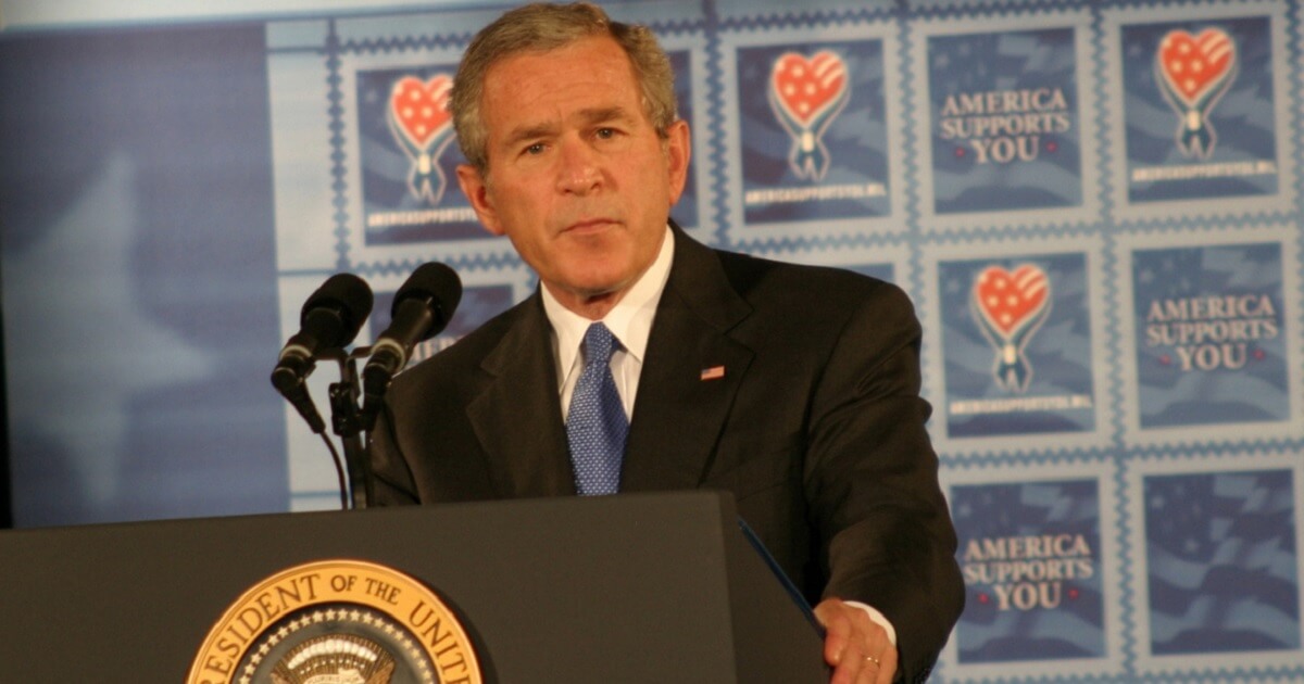 George W. Bush at a podium bearing the presidential seal.