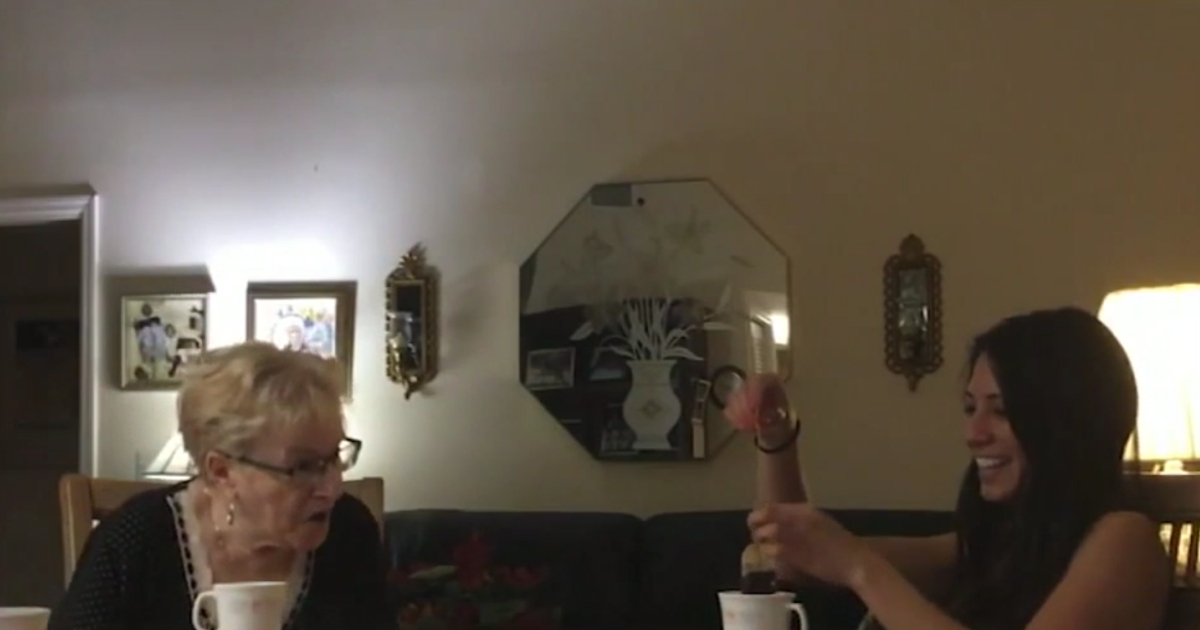 A grandmother shocked as her granddaughter pulls out a tea bag with an engagement ring attached.
