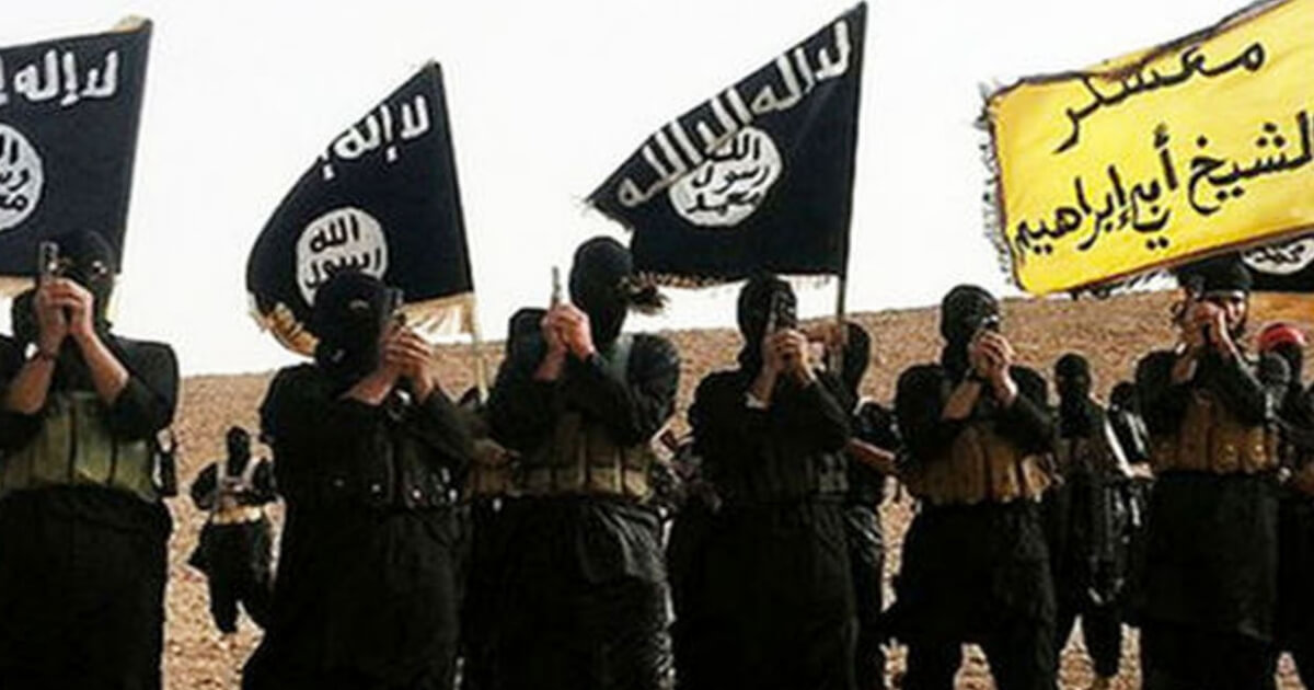 Masked ISIS fighters flying the ISIS flag.