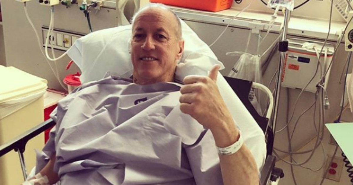 Jim Kelly in hospital bed before surgery.