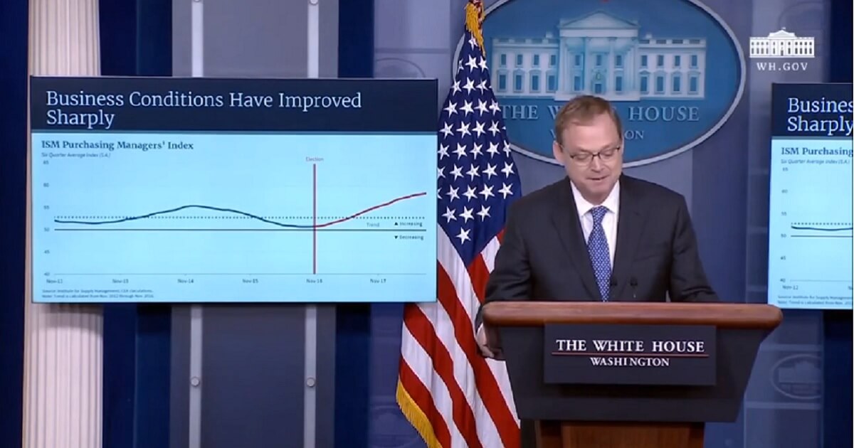 White House economist stands in front of a chart with the title "Business Conditions Have Improved Sharply"