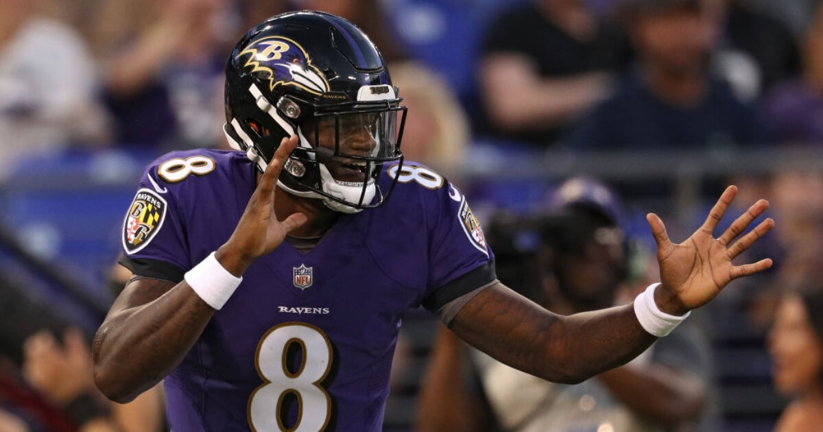 Lamar Jackson of the Baltimore Ravens celebrates after scoring a touchdown during a preseason game in Baltimore.