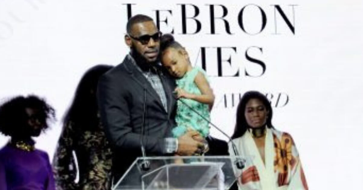 Basketball star LeBron James, holds his daughter Zhuri, as he accepts Harlem Fashion Row's ICON 360 Award for his contribution to fashion and philanthropy at the HFR fashion show and awards ceremony before the start of New York Fashion Week, Tuesday, Sept. 4.