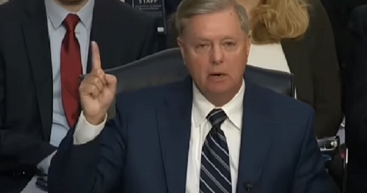 Lindsey Graham pointing in the air.