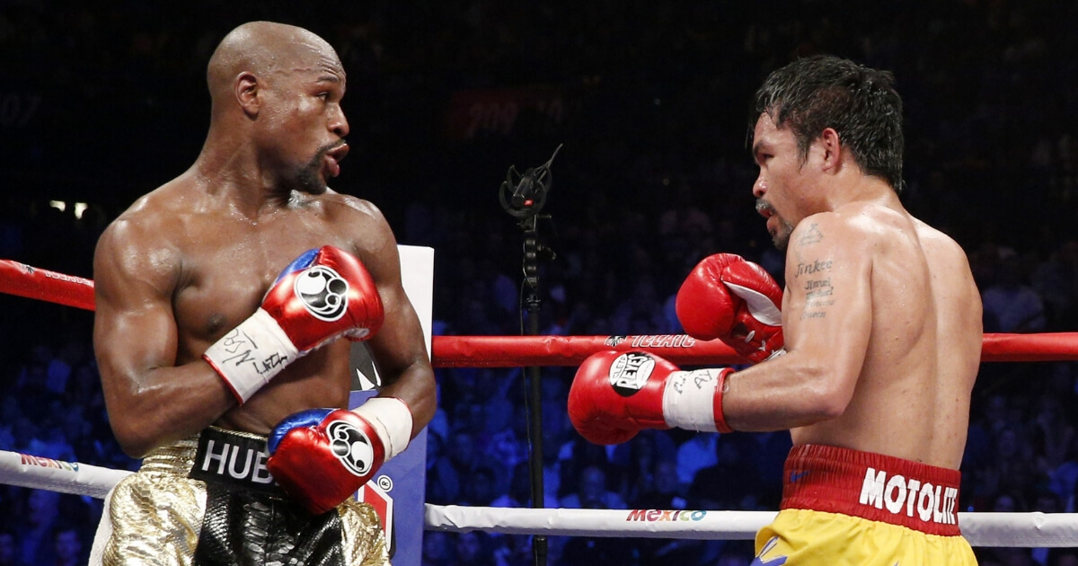 Floyd Mayweather Jr. exchange punches with Manny Pacquiao during their welterweight unification championship bout May 2, 2015, at MGM Grand Garden Arena in Las Vegas. Mayweather defeated Pacquiao by unanimous decision.