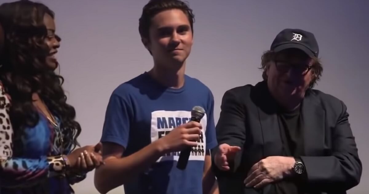 Film director Michael Moore reaches for the microphone to end anti-gun activist David Hogg's embarrassing moment at the Toronto Film Festival on Friday.