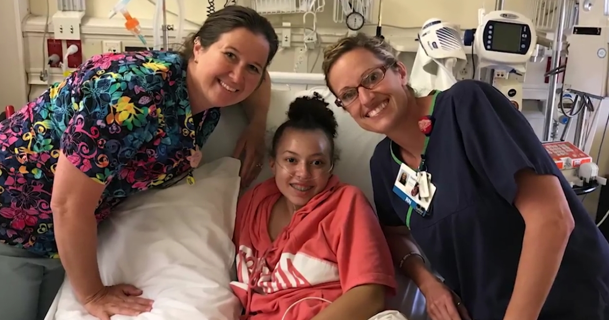 Young teen with two nurses.