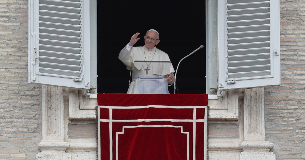 Pope Francis delivers a blessing as he recites the Angelus noon prayer from his studio's window overlooking St. Peter's Square at the Vatican.