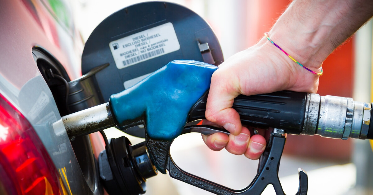 A closeup of gas being pumped into a car.