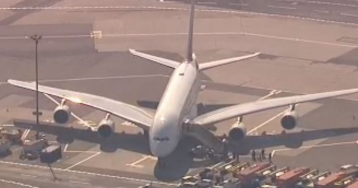 An Emirates plane is quarantined at New York's JFK airport after arriving from Dubai. Reports suggest that as many as 100 people on the flight became ill.