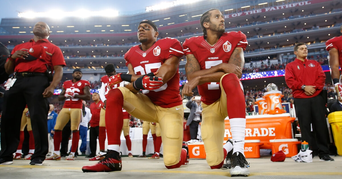 Eric Reid, left, and Colin Kaepernick of the San Francisco 49ers kneel during the national anthem prior to a game against the Los Angeles Rams at Levi Stadium on Sept. 12, 2016.