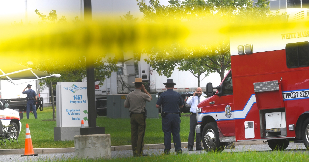 Police officers gather in front of a Rite Aid Distribution Center where multiple people were killed and injured in a shooting Thursday in Aberdeen, Maryland.