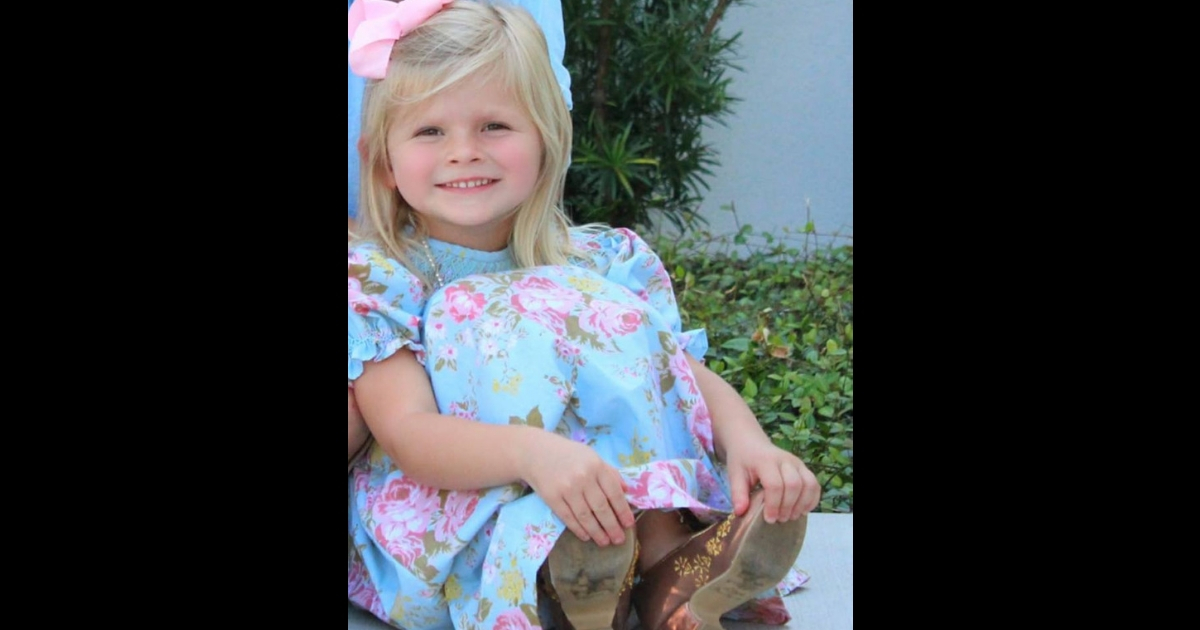 Blonde little girl in a light blue dress.