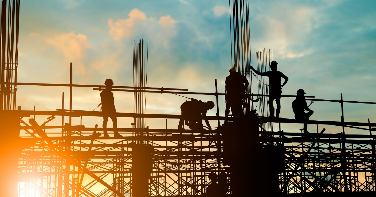 Silhouette of engineer and construction team working safely on scaffolding on high rise building. over blurred background sunset pastel for industry background
