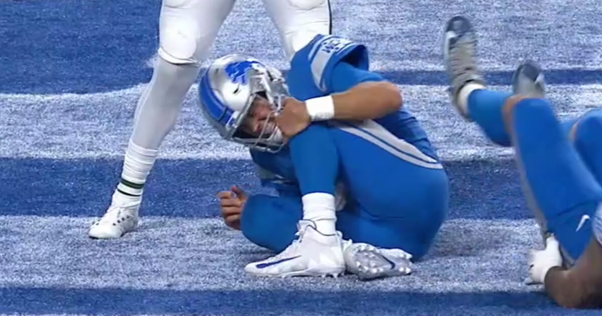 Lions quarterback Matthew Stafford grabs his knee after getting hit during Detroit's season-opening loss to the New York Jets.