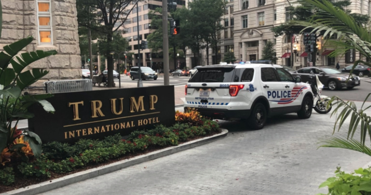 Police patrol outside the Trump International Hotel in Washington, D.C. on Tuesday after a Twitter user threatened a mass shooting.