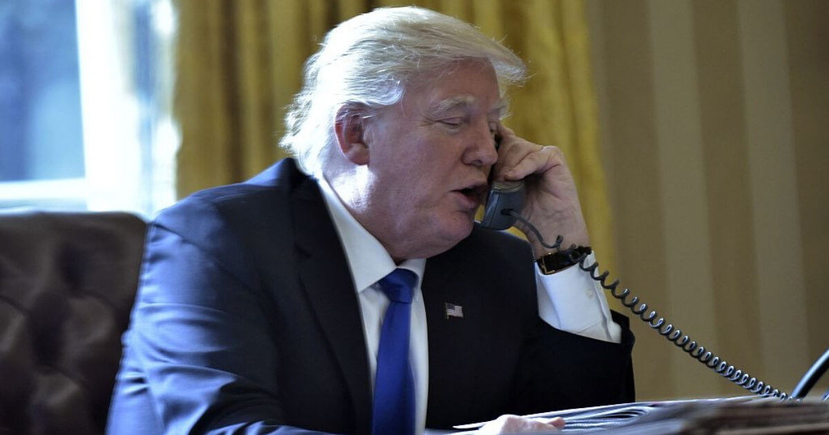 President Donald Trump speaks on the phone while in the Oval Office in January 2017.