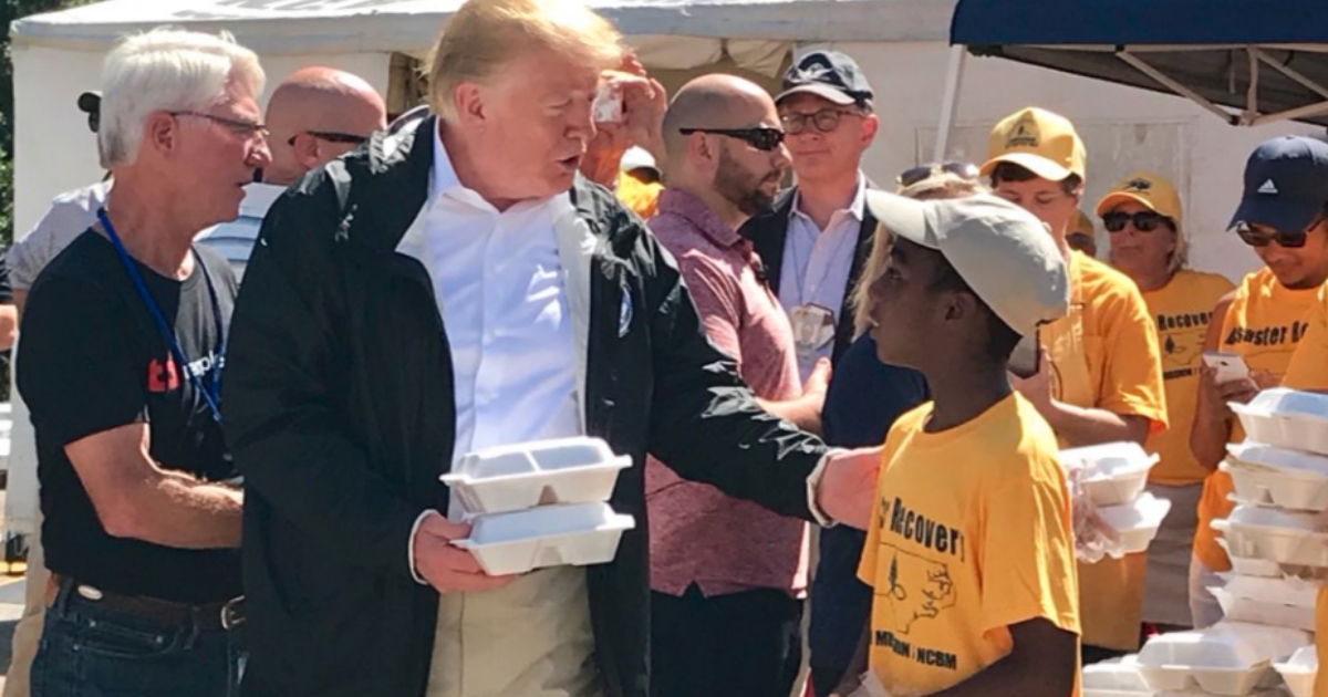 President Donald Trump visits with a young volunteer at Temple Baptist Church in New Bern, North Carolina as they hand out meals to survivors of Hurricane Florence.