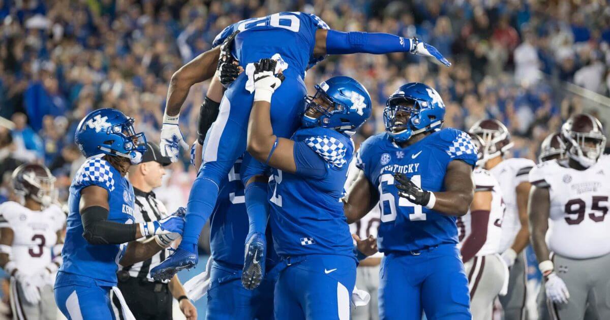 Kentucky running back Benny Snell Jr. (26) is hoisted in celebration following his touchdown during the Wildcats' win over Mississippi State on Saturday.