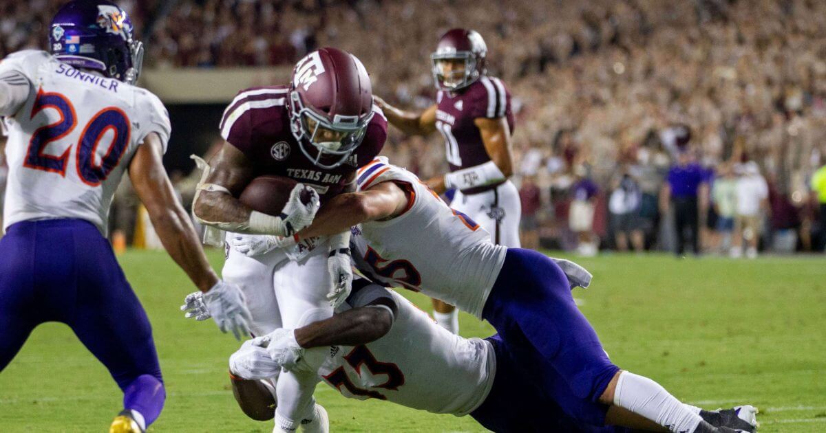 Texas A&M running back Trayveon Williams (5) fights off Northwestern State defenders on his way to a touchdown during the first half of NCAA college football game Thursday, Aug. 30, 2018, in College Station, Texas.