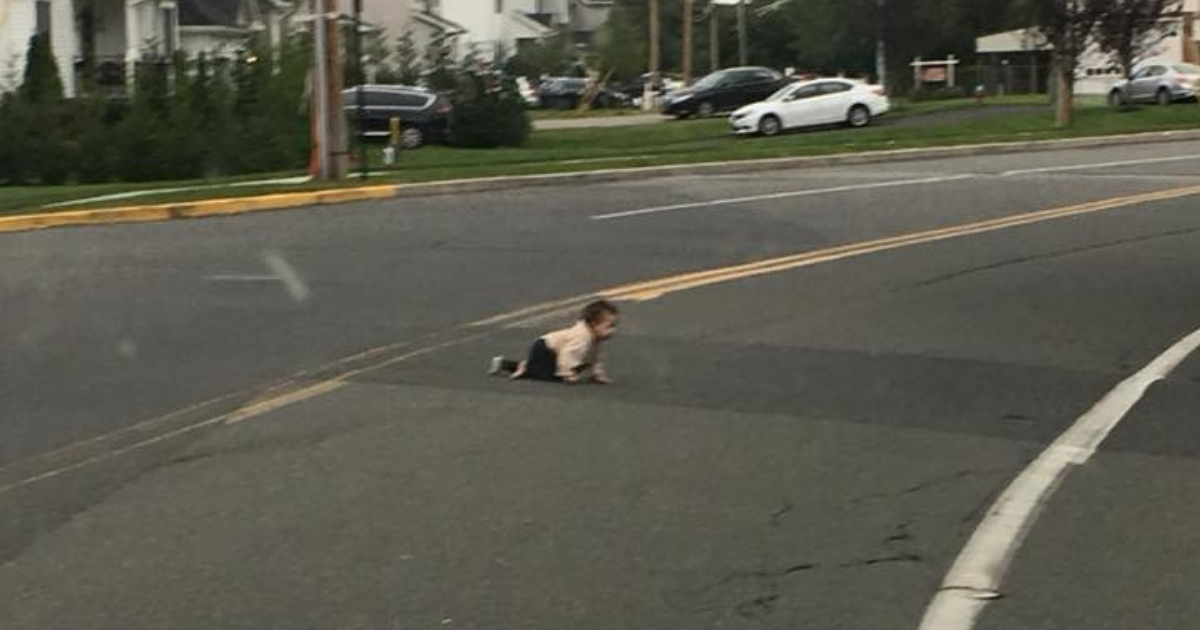 Baby crawling across the street.
