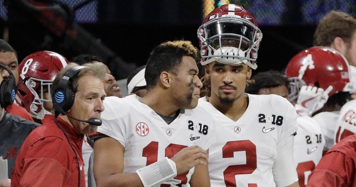 Alabama quarterbacks Jalen Hurts (2) and Tua Tagovailoa (13) and head coach Nick Saban watch from the sideline during the NCAA college football playoff championship game against Georgia in January.