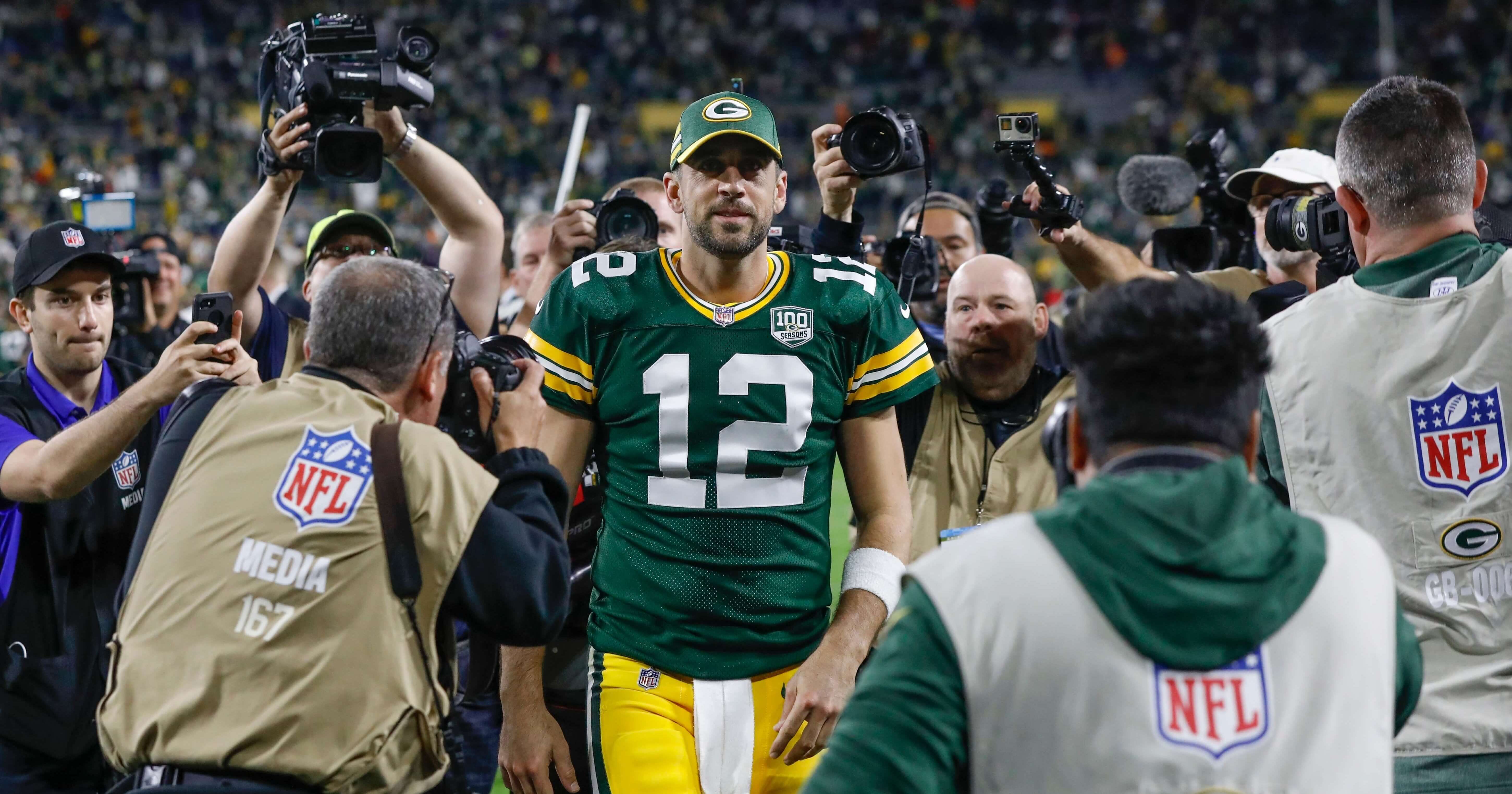 Green Bay Packers quarterback Aaron Rodgers walks off the field after leading his team to a 24-23 comeback victory at Lambeau Field