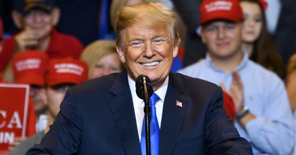 President Donald Trump smiling into a crowd.