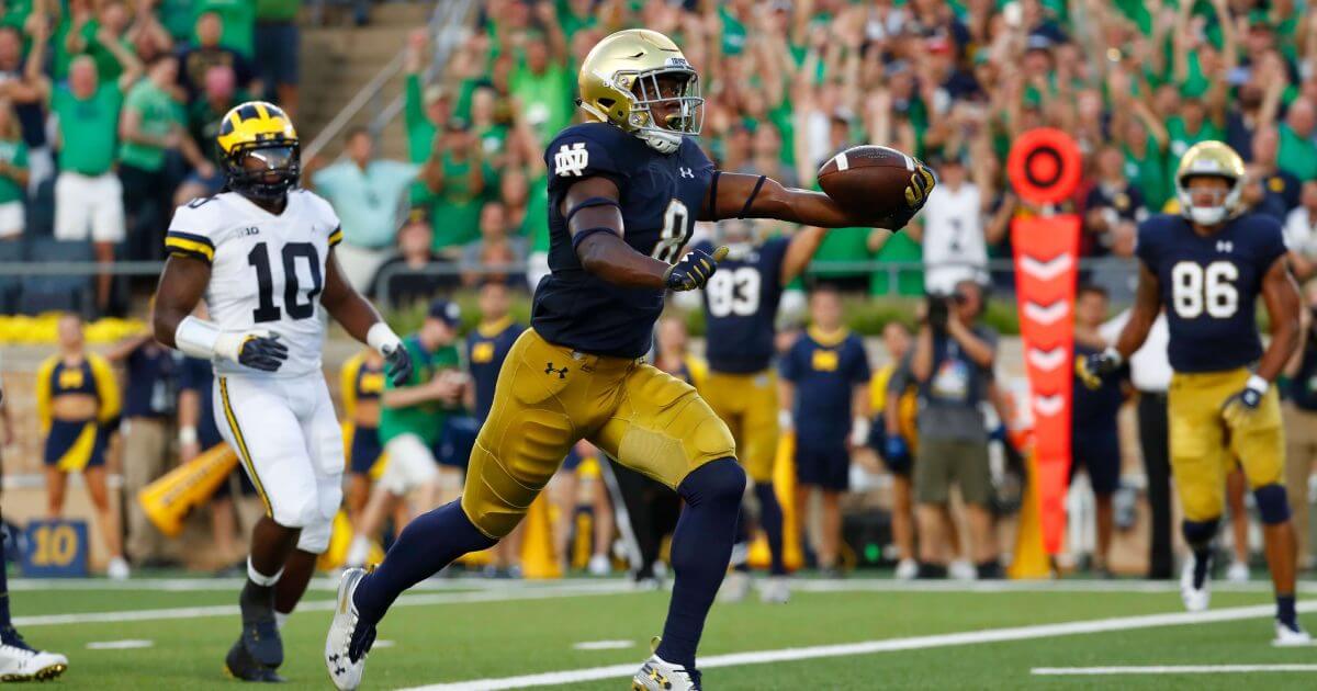 Notre Dame wide receiver Jafar Armstrong (8) scores a touchdown in front of Michigan linebacker Devin Bush (10) in the first half of an NCAA football game in South Bend, Ind., Saturday.