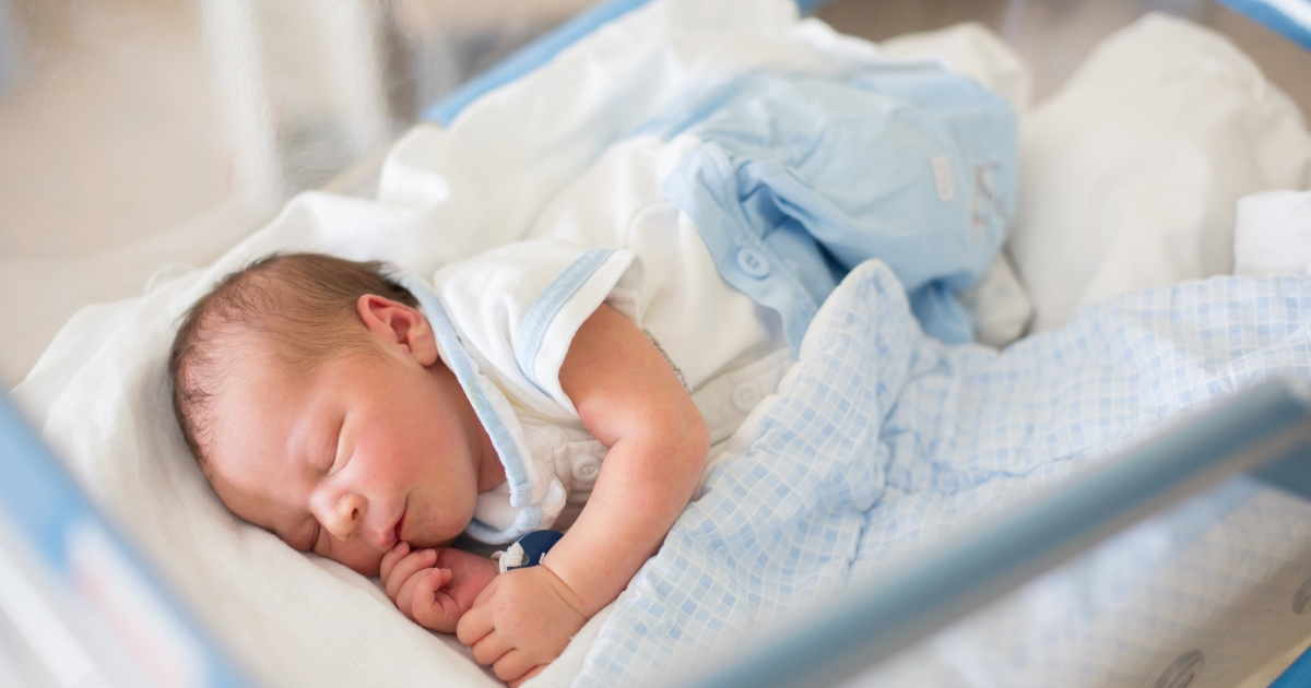 Newborn in crib at hospital.
