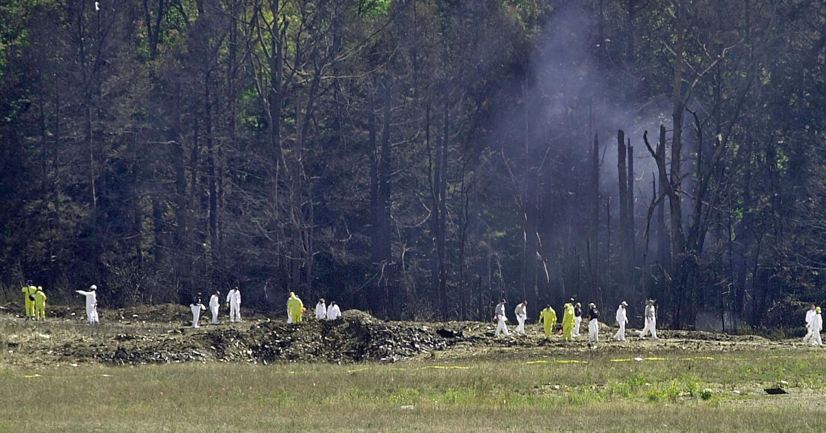 Investigative personnel search the crash site of United Airlines Flight 93