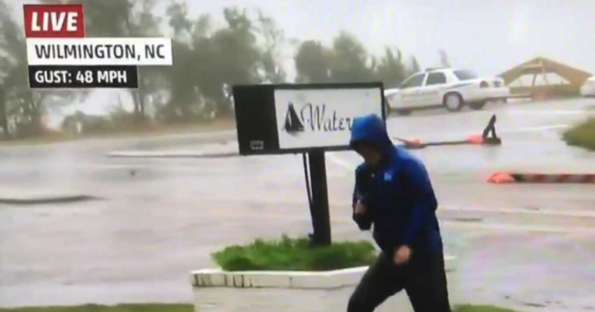 Weather Channel reporter fakes wind strength.