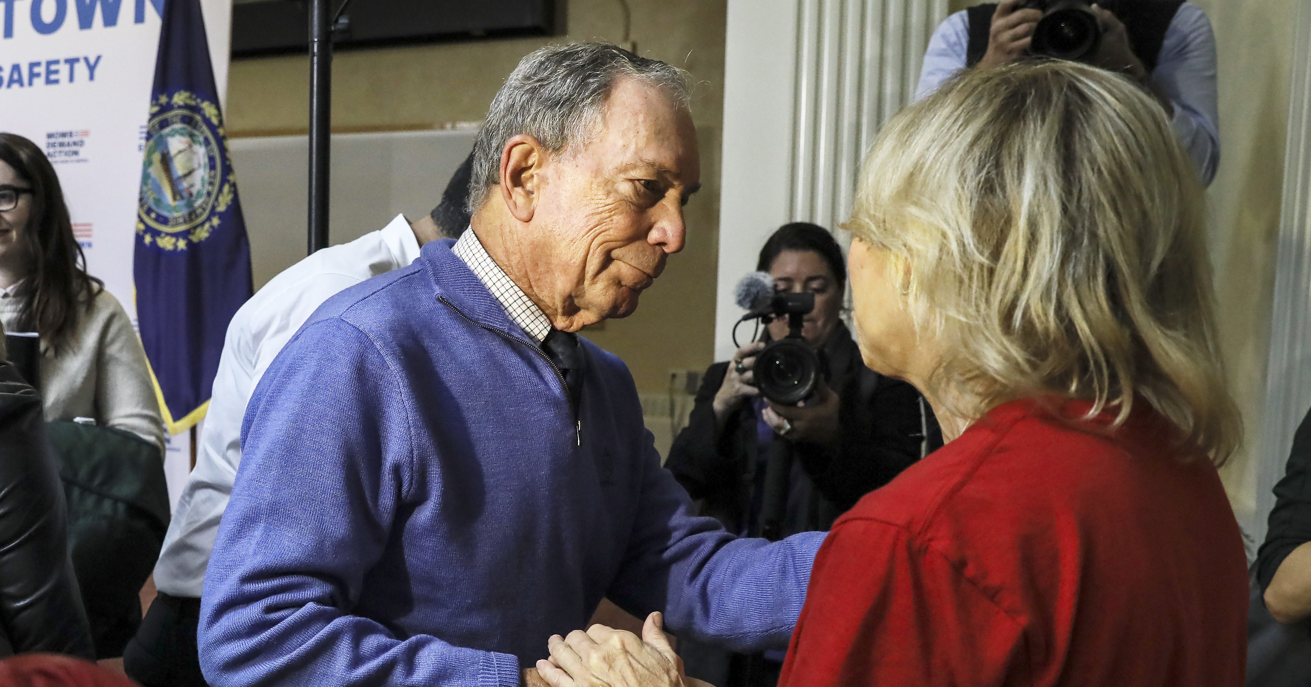 Former New York Mayor Michael Bloomberg talks to a woman