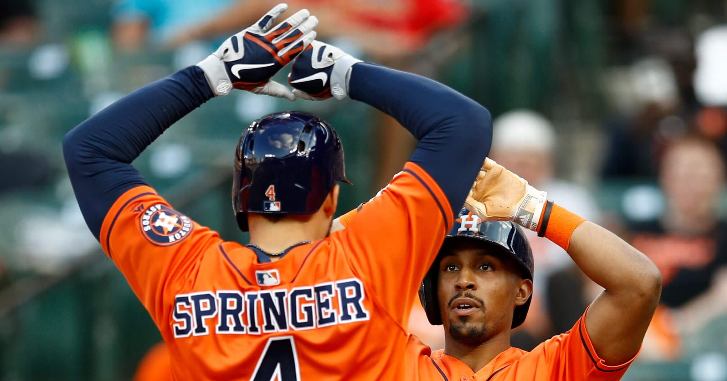 Houston Astros' Tony Kemp, right, high-fives teammate George Springer after scoring on Springer's two-run home run in the sixth inning of the first game of a doubleheader against the Baltimore Orioles on Saturday.