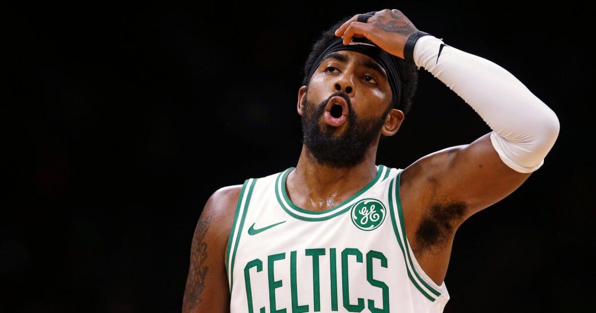 Boston Celtics guard Kyrie Irving reacts during the first quarter of a preseason basketball game against the Charlotte Hornets on Sunday.