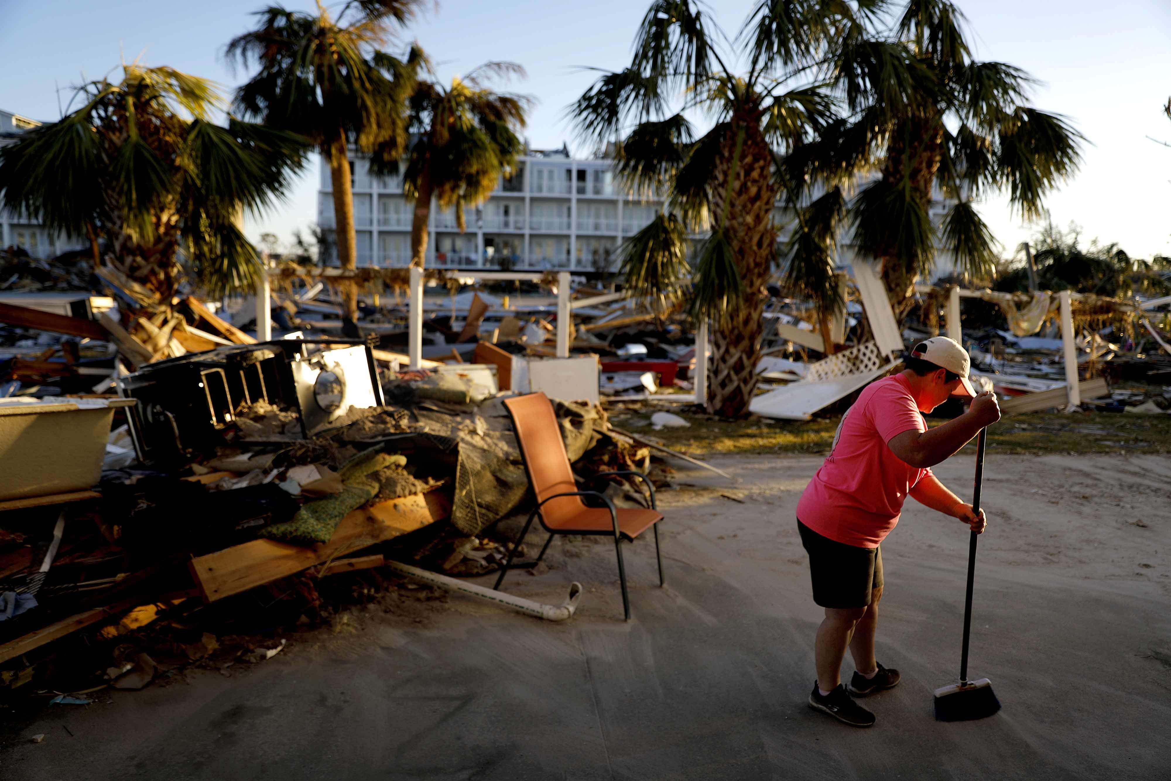 Peggy Cauley cleans up debris from her family's home in the aftermath of hurricane Michael