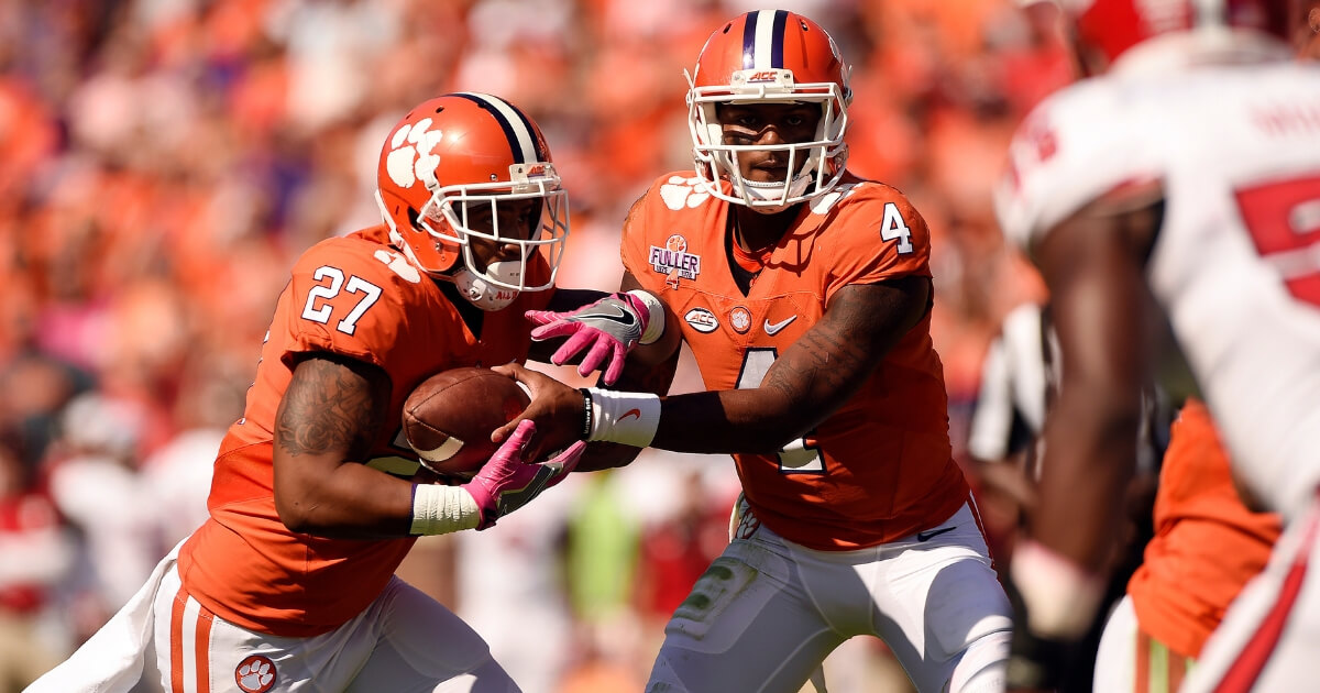 Clemson running back C.J. Fuller gets the handoff from quarterback Deshaun Watson in a home game against North Carolina State on Oct. 15, 2016.