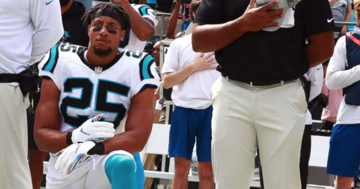 Caroline Panthers safety Eric Reid takes a knee during the national anthem.