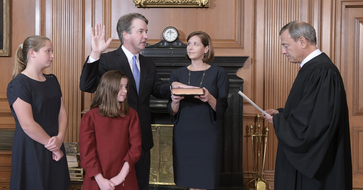 Chief Justice John G. Roberts Jr. administers the Constitutional Oath to Judge Brett M. Kavanaugh in the Justices Conference Room, Supreme Court Building, Oct. 6, 2018, in Washington, D.C. Mrs. Ashley Kavanaugh holds the Bible.