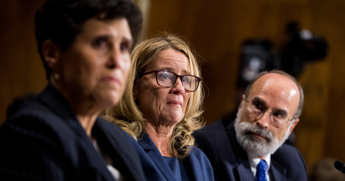 Christine Blasey Ford, center, is flanked by attorneys Debra Katz, left, and Michael Bromwich during her testimony before the Senate Judiciary Committee hearing on the Supreme Court nomination of Brett Kavanaugh.
