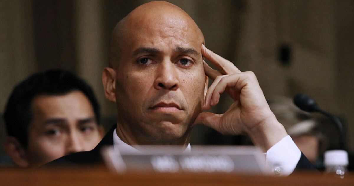 New Jersey Sen. Cory Booker grimaces during a confirmation hearing for Supreme Court Justice Brett Kavanaugh.
