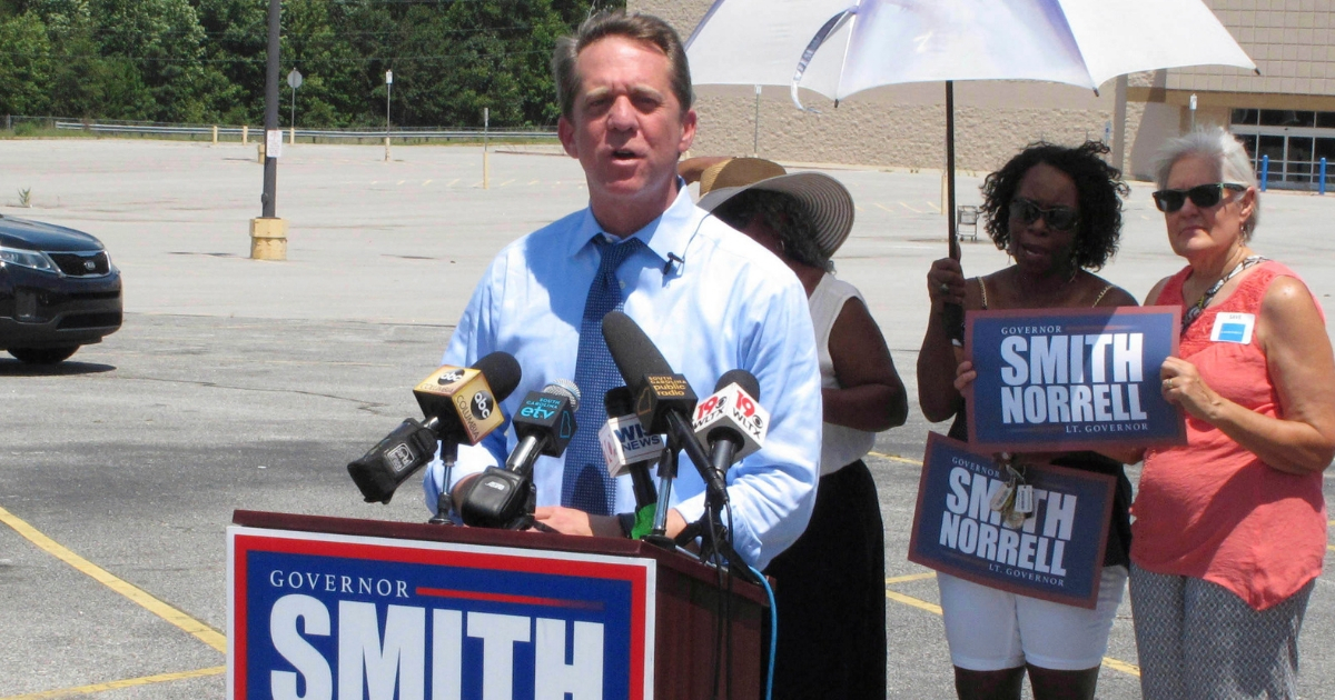 Democratic candidate for governor in South Carolina, state Rep. James Smith, talks about President Donald Trump's tariffs outside a closed Walmart on Aug. 8, 2018, in Winnsboro, S.C.