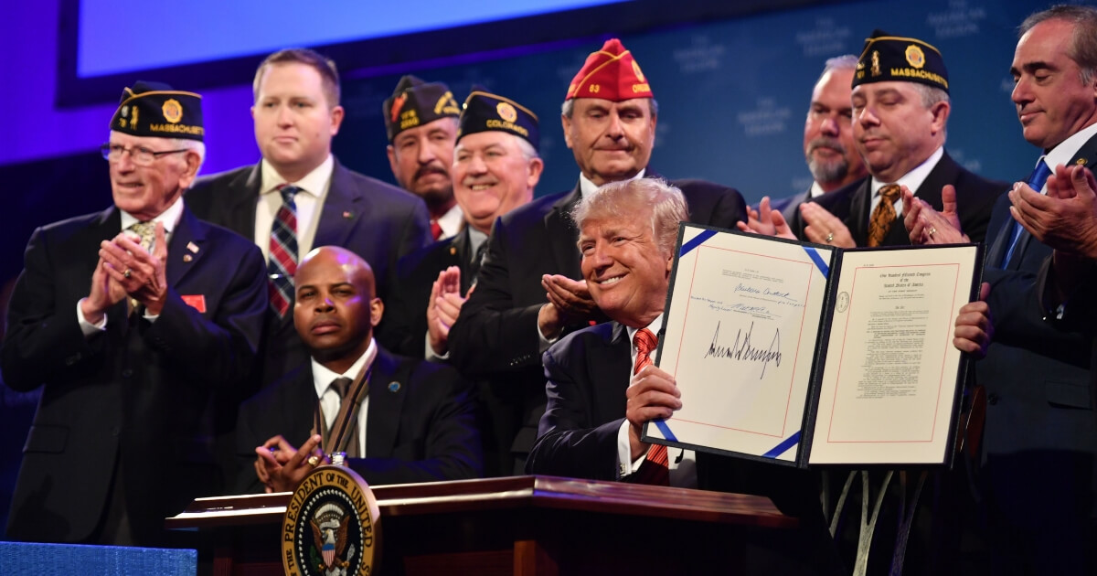 President Donald Trump shows his signature after signing the Veterans Appeals Improvement and Modernization Act into law at the American Legion national convention on Aug. 23, 2017, in Reno, Nevada.