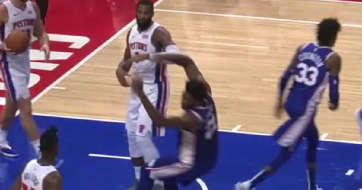 Philadelphia's Joel Embiid drops to the floor in an attempt to draw a foul on Detroit's Andre Drummond during the Pistons' 132-130 victory.